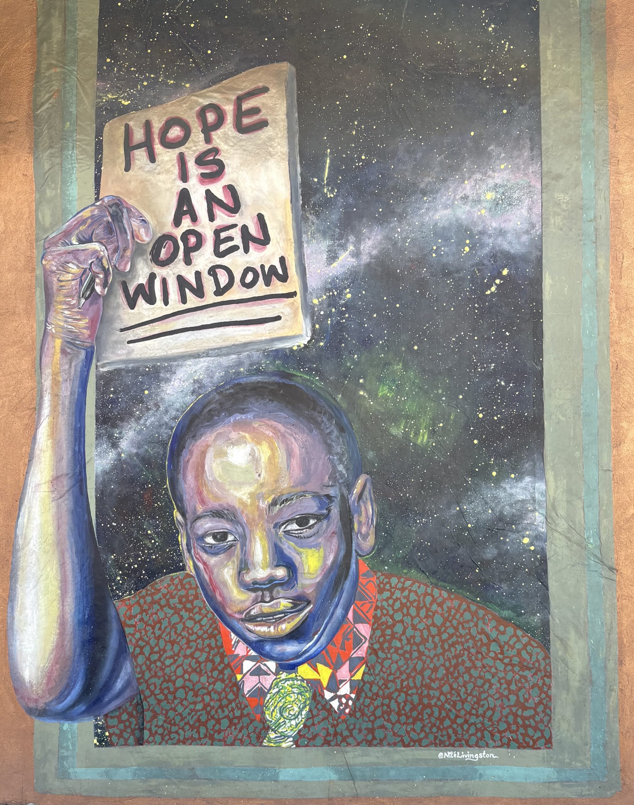 Colorful mural of a person holding a sign that reads Hope Is an Open Window